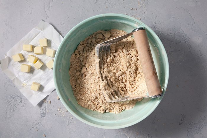Flour mixture in a large bowl with cubes of butter