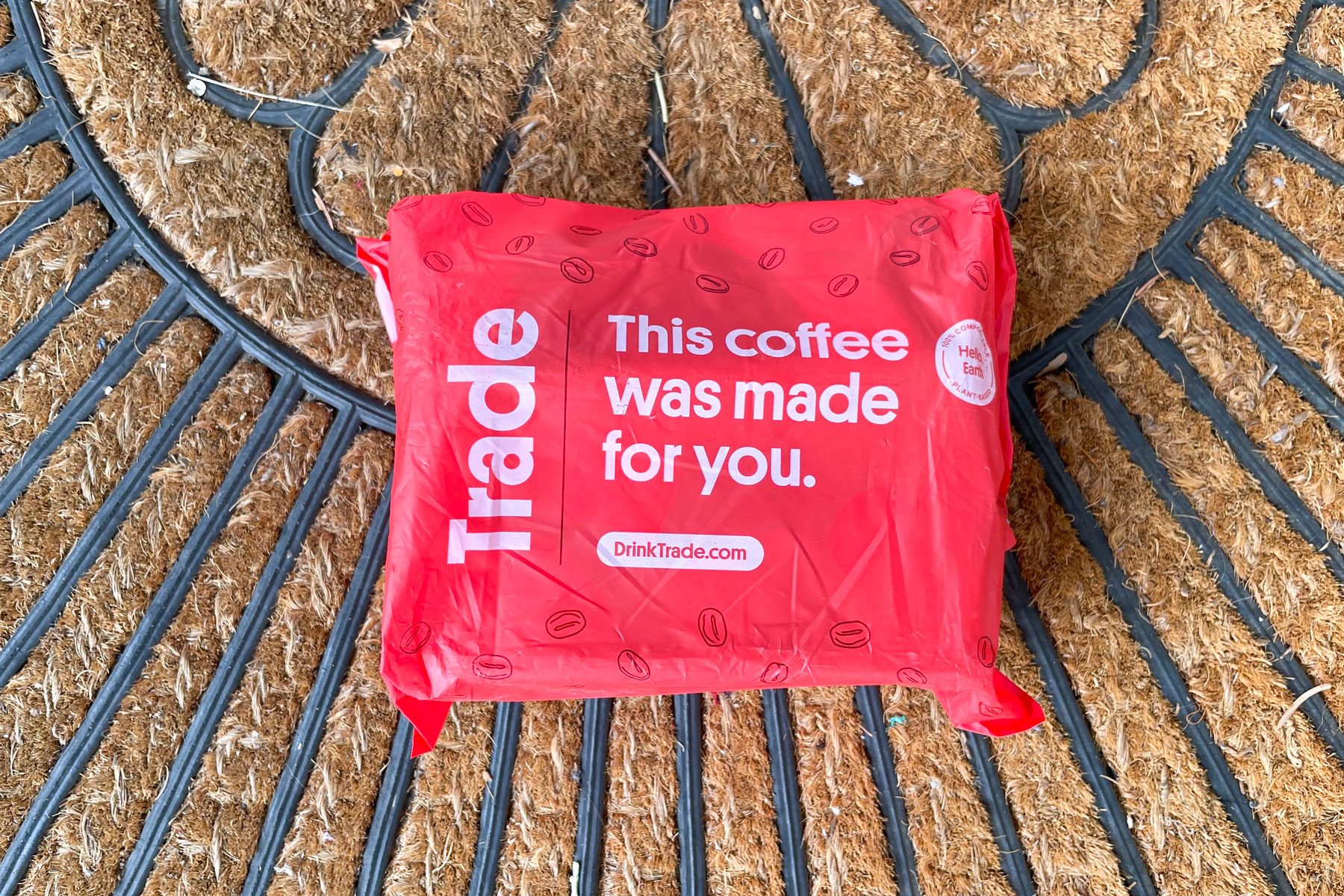 A box coved in a red bag placed on brown matt 