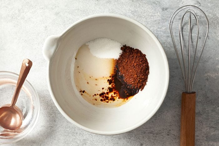 overhead shot of ingredients for Whipped Coffee (Dalgona Coffee) in a large white bowl with a whisker