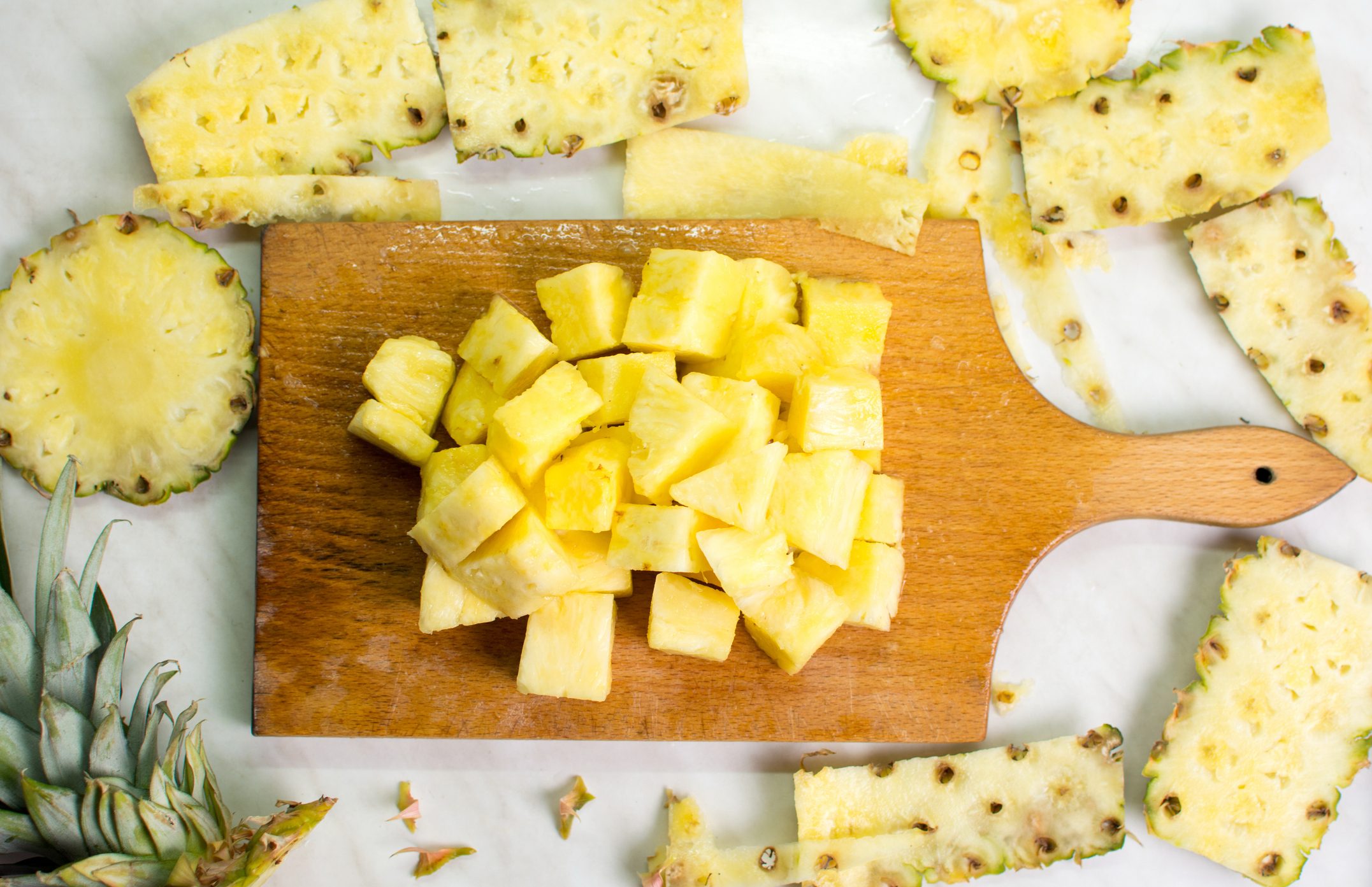 Pineapple fruit slices on a kitchen board