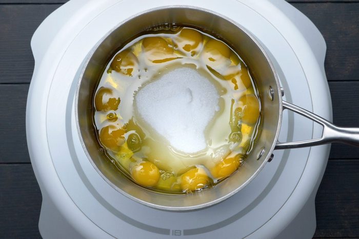 overhead shot of eggs, sugar and salt in a large saucepan