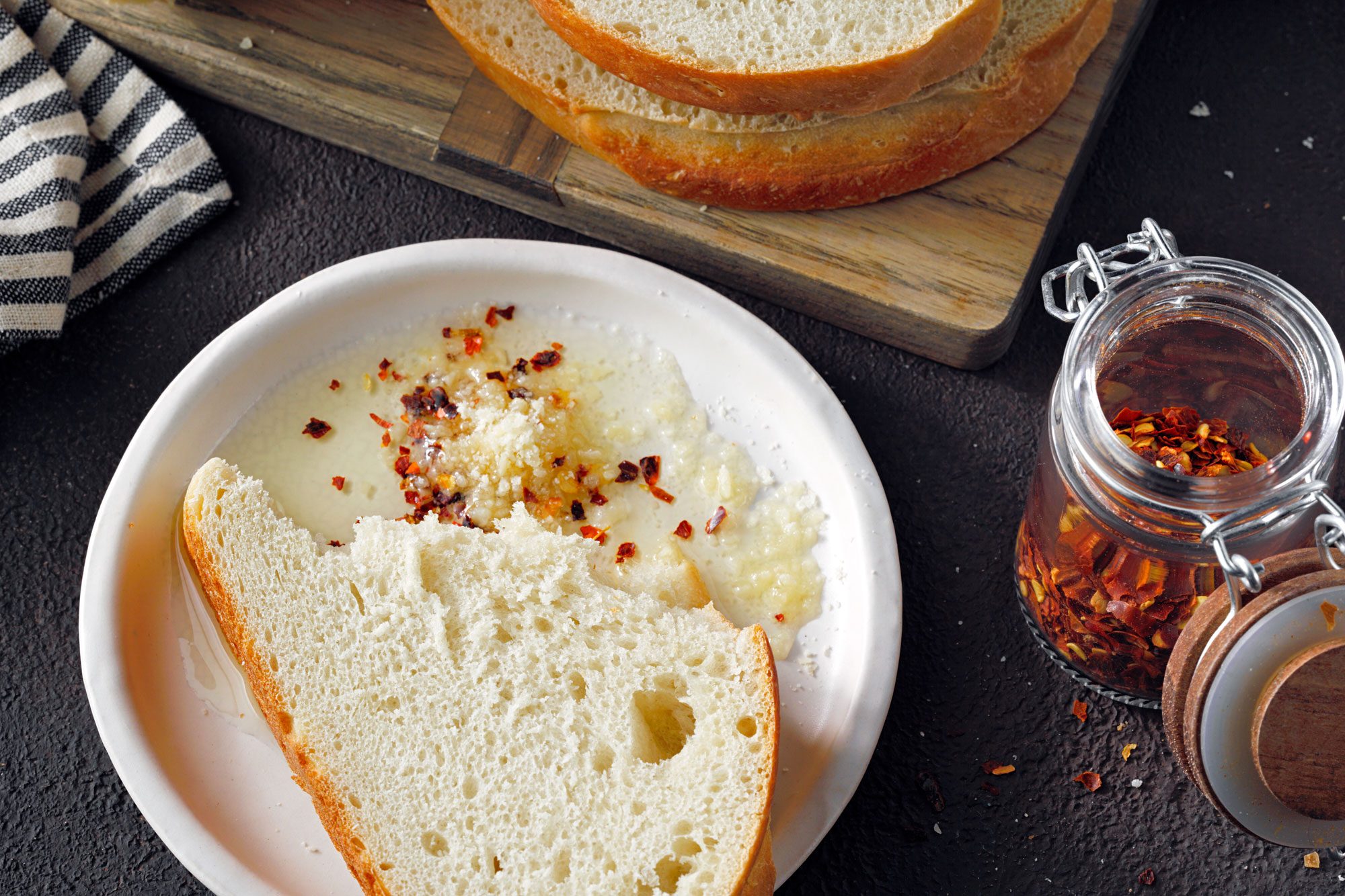 Mom's Italian Bread sliced and served with cilli flakes and cheese