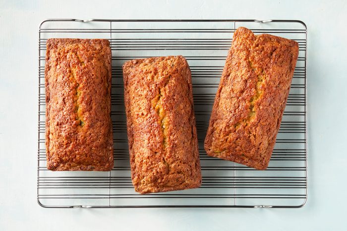 overhead shot of pina colada zucchini bread loaf on a wired rack