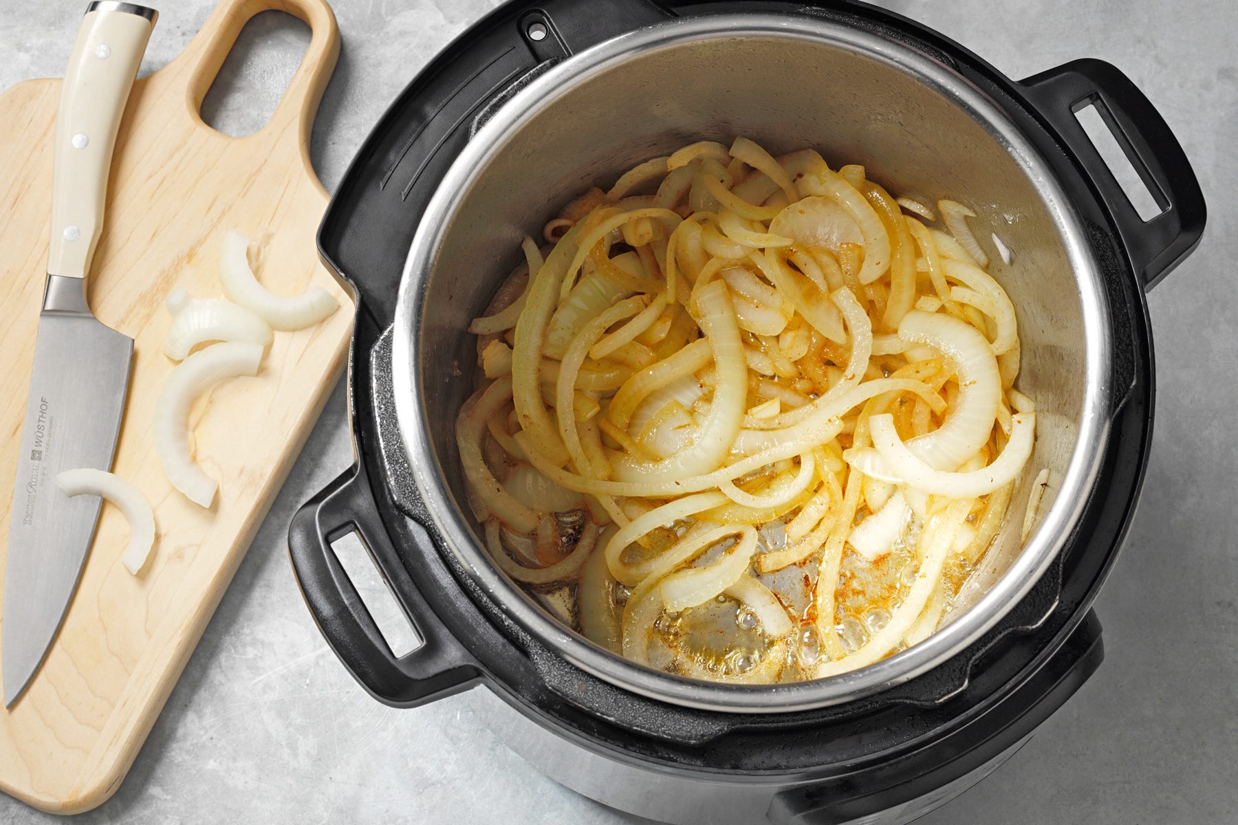 Onions are being cooked in a pressure cooker.