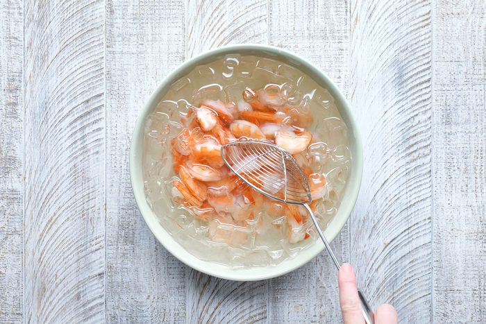 overhead shot of shrimps in a bowl of ice water
