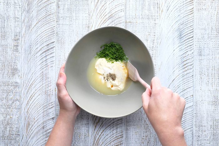 overhead shot of mayonnaise, lemon juice, dill in a large bowl