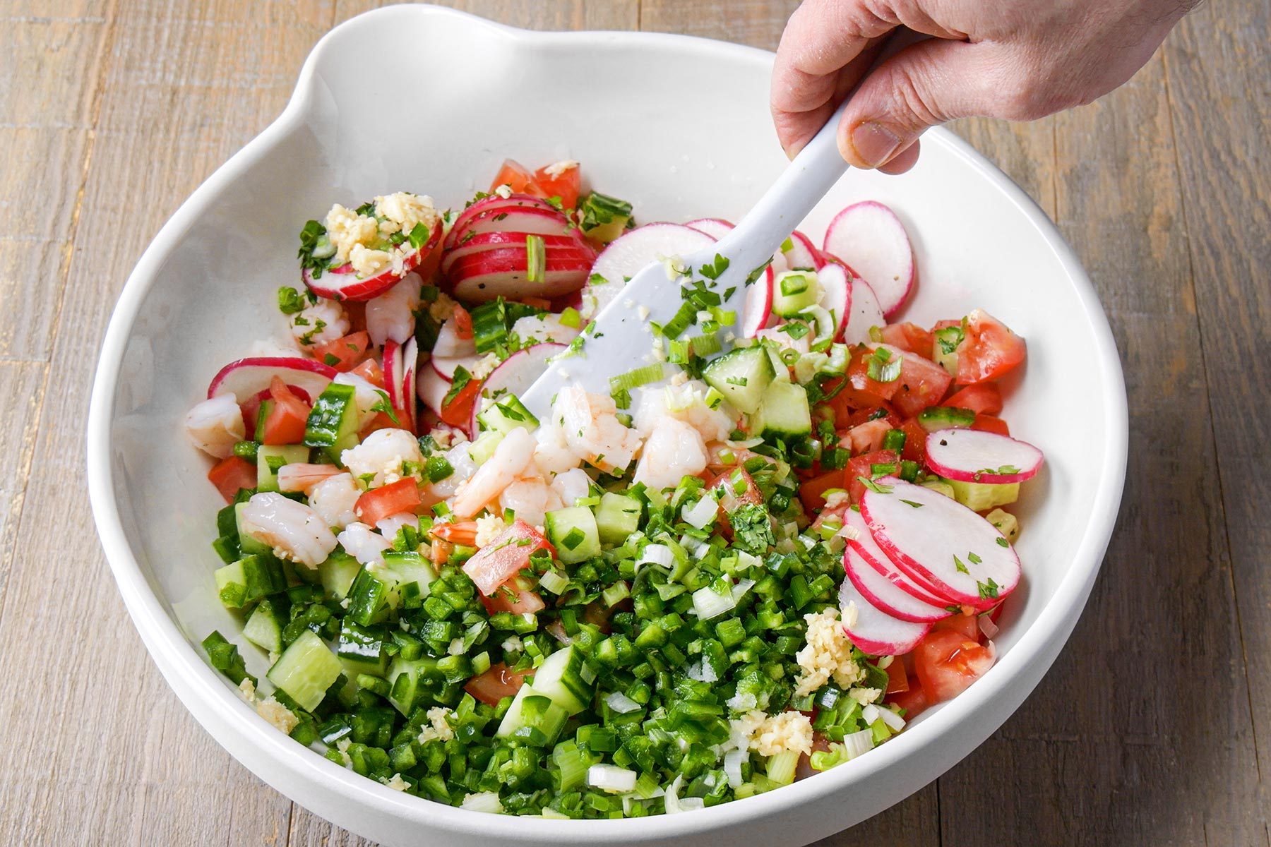 Stirring the vegetable mixture in large bowl
