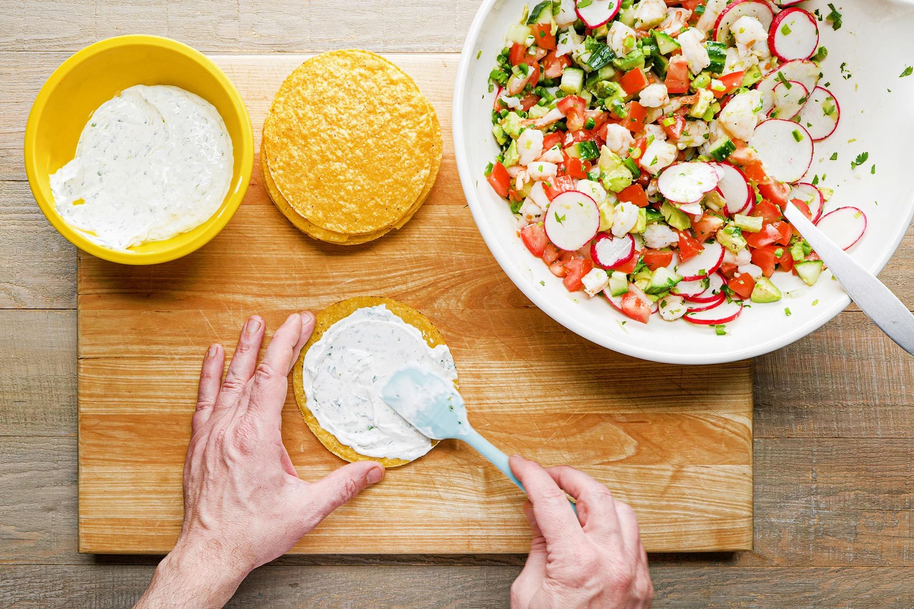 Spreading tostada with sauce
