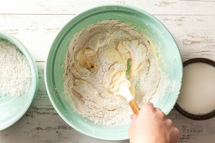 A person mixing ingredients in a bowl