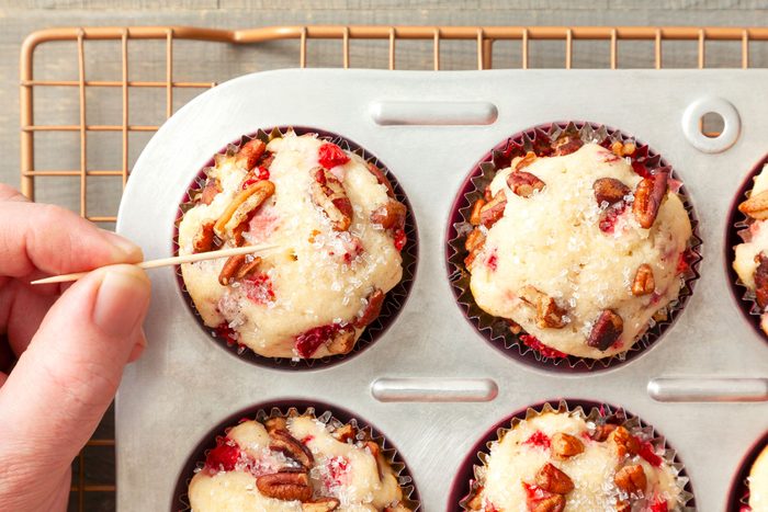 Strawberry Muffins in a Muffin Tray on a Wooden Surface