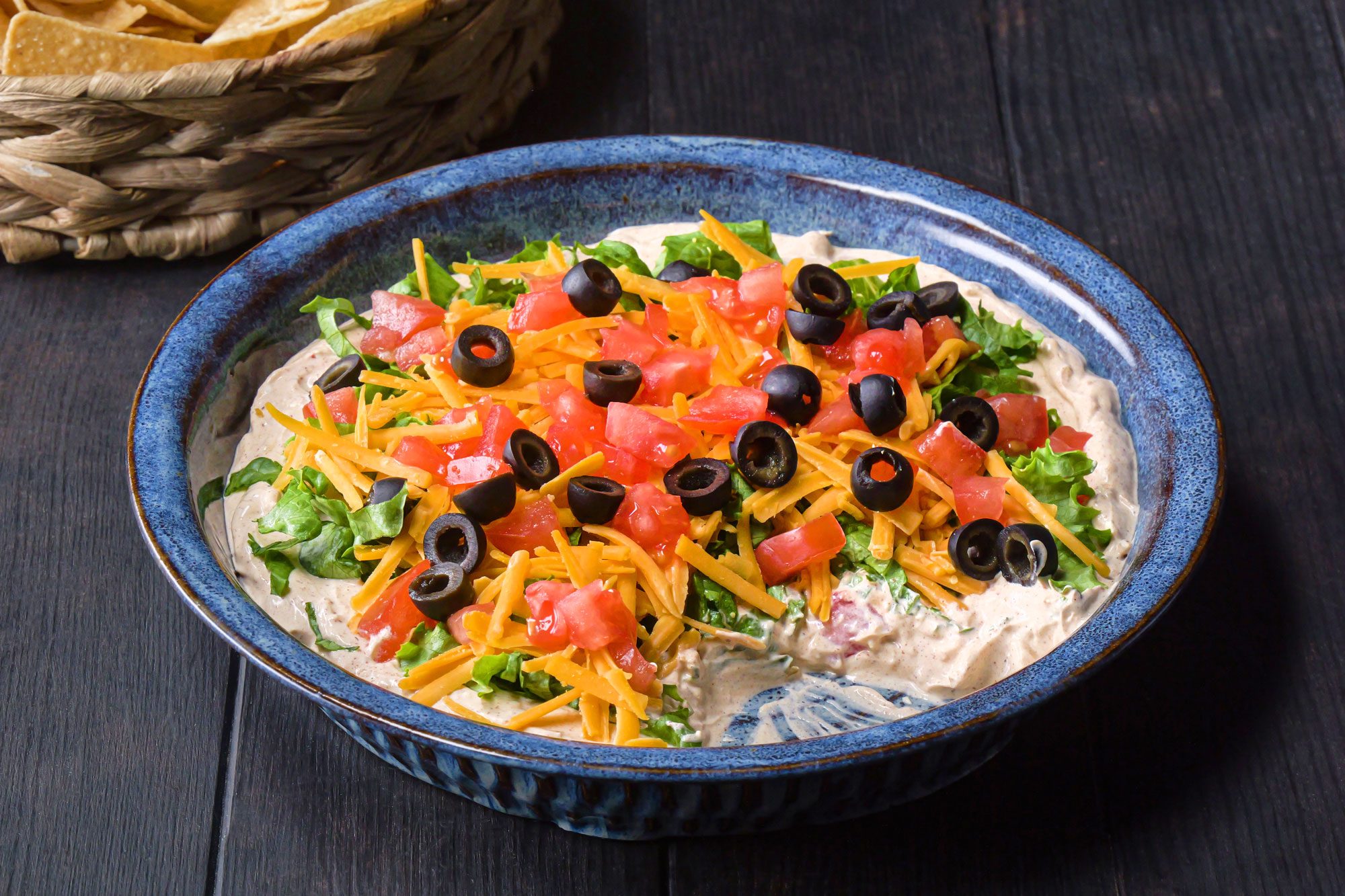 Taco Dip in a pie plate on wooden surface
