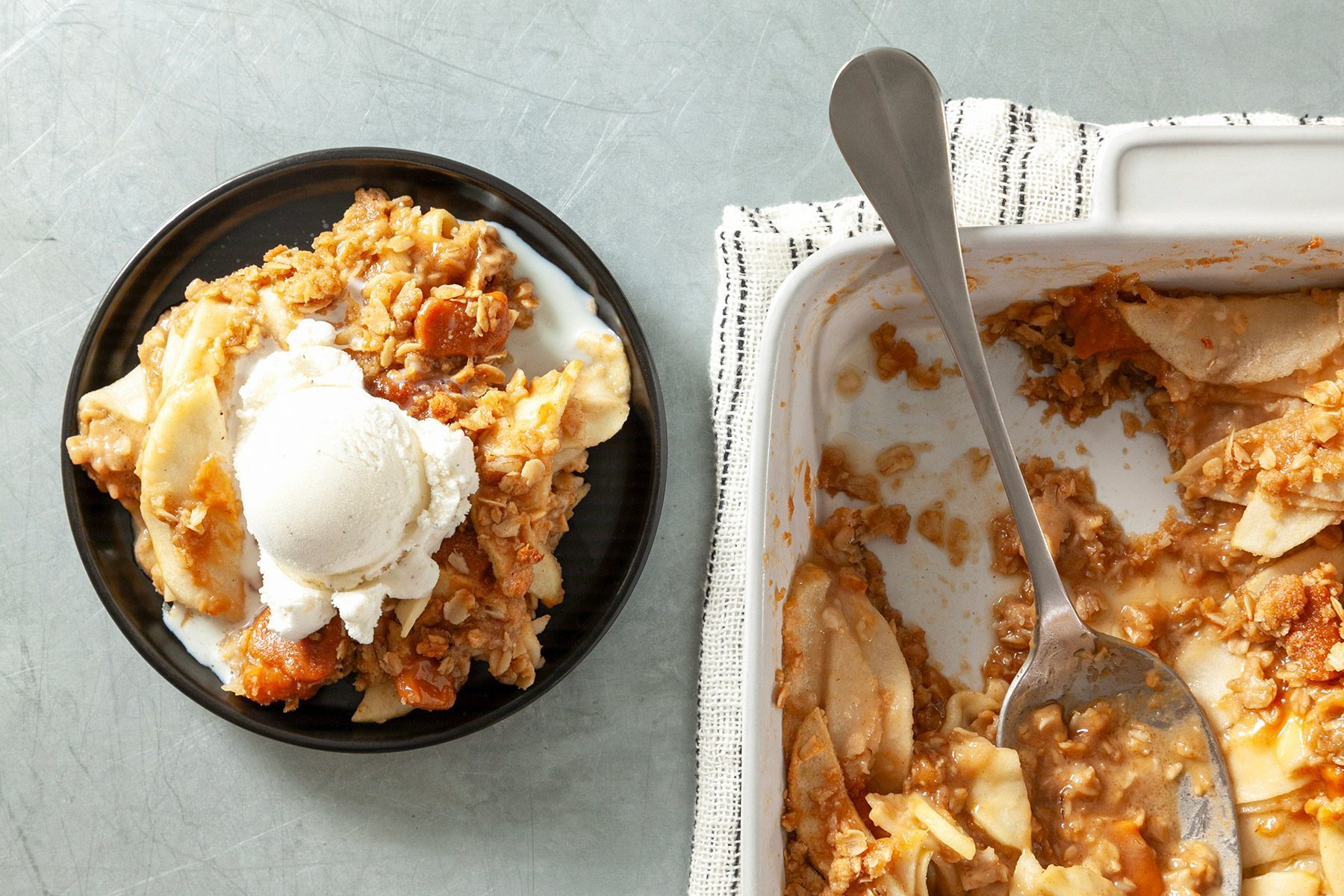 wide shot of caramel apple crisp served with ice cream