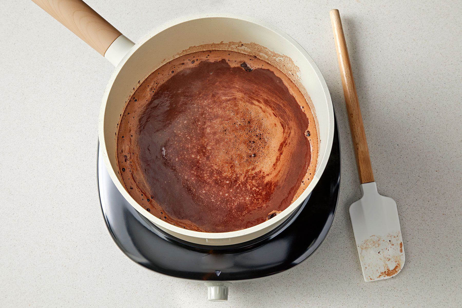 overhead shot of cocoa mix in a saucepan with spatula