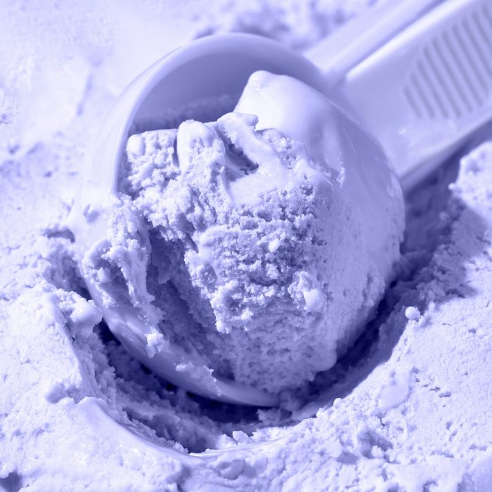 Close up of scoop with ice cream ball. Toning in the color of the year 2022, very peri. Trendy colors concept.