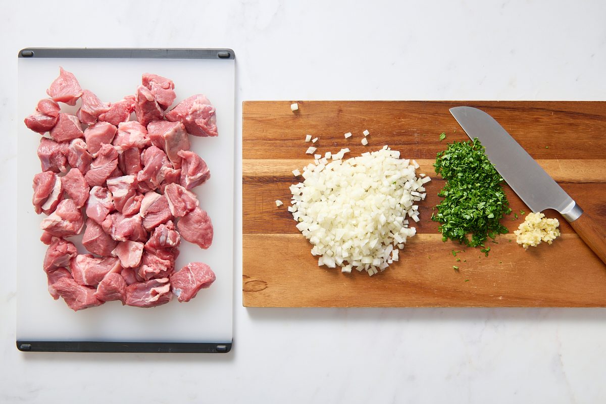 Chopping and prepping ingredients for lamb kabobs