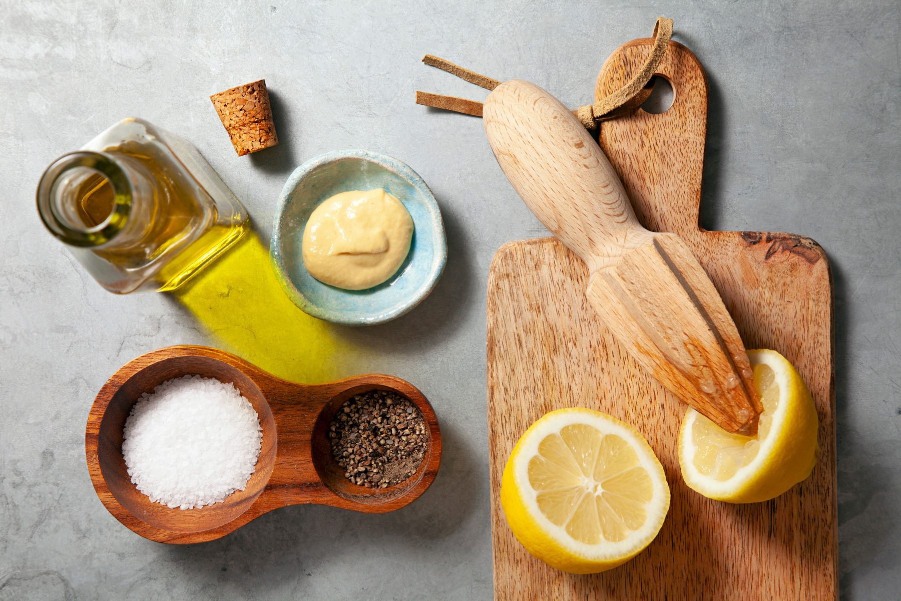 Lemon wedges, olive oil, and other ingredients for Lemon Vinaigrette