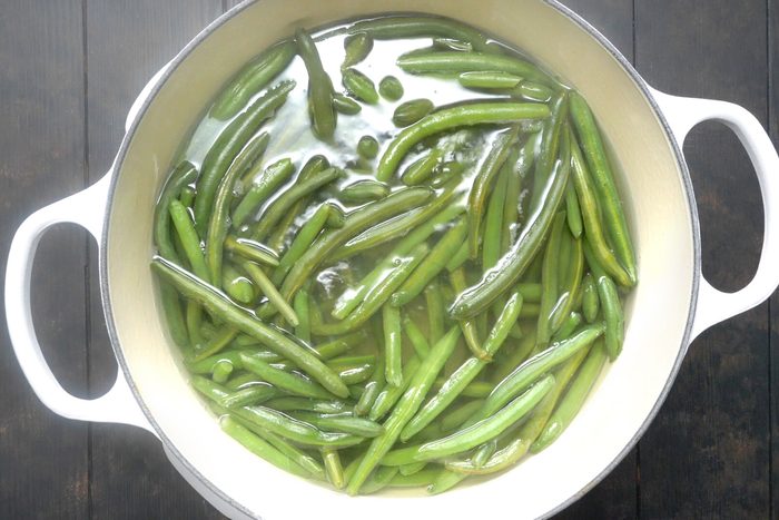 Green Beans boiling in water in a Dutch oven