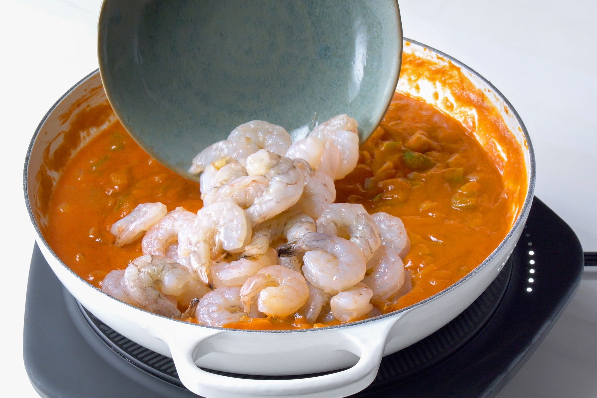 putting raw shrimp in Shrimp Etouffee sauce