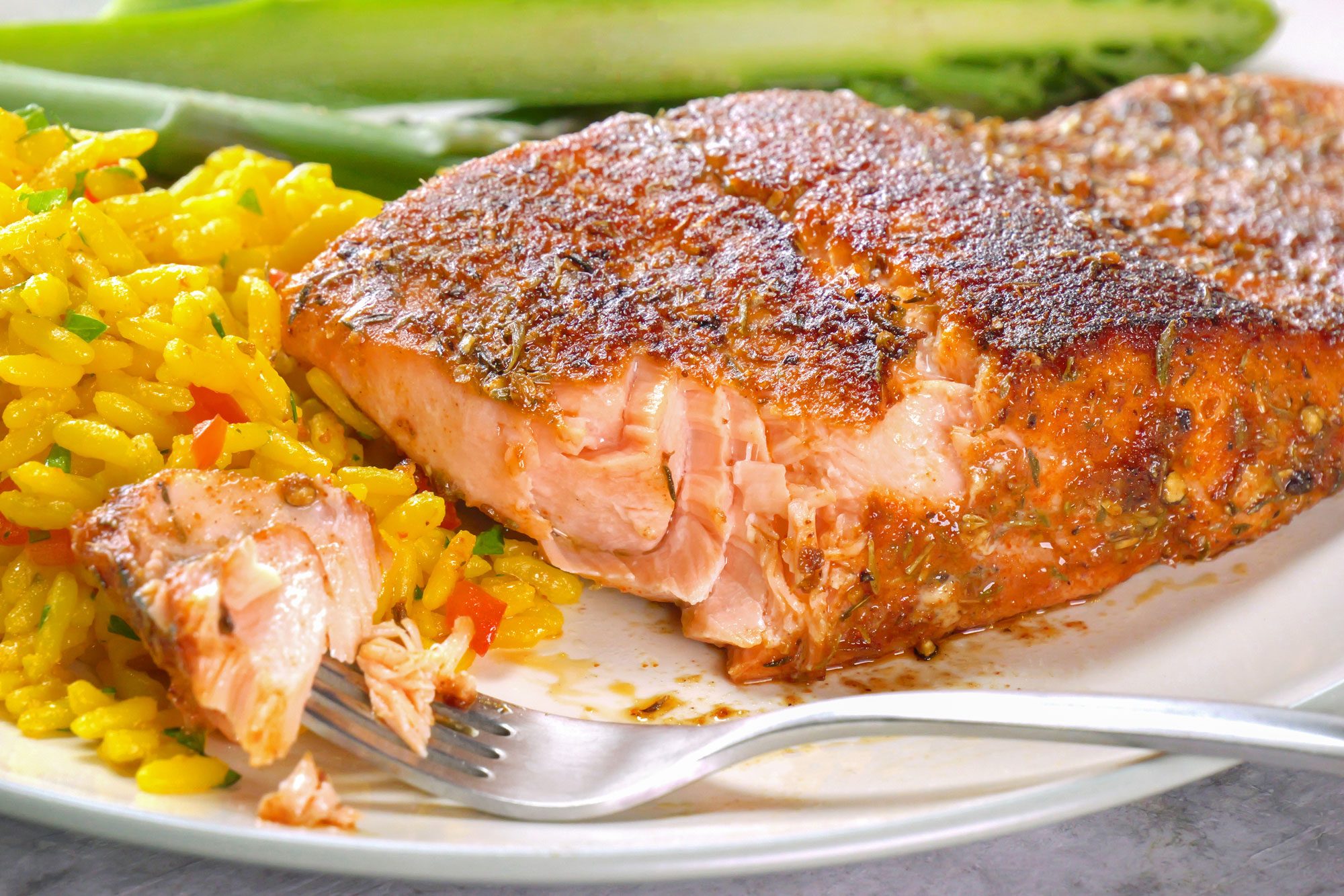 Blackened Salmon served with rice and veggies in a serving plate