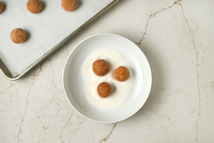 Roll dough balls in sugar