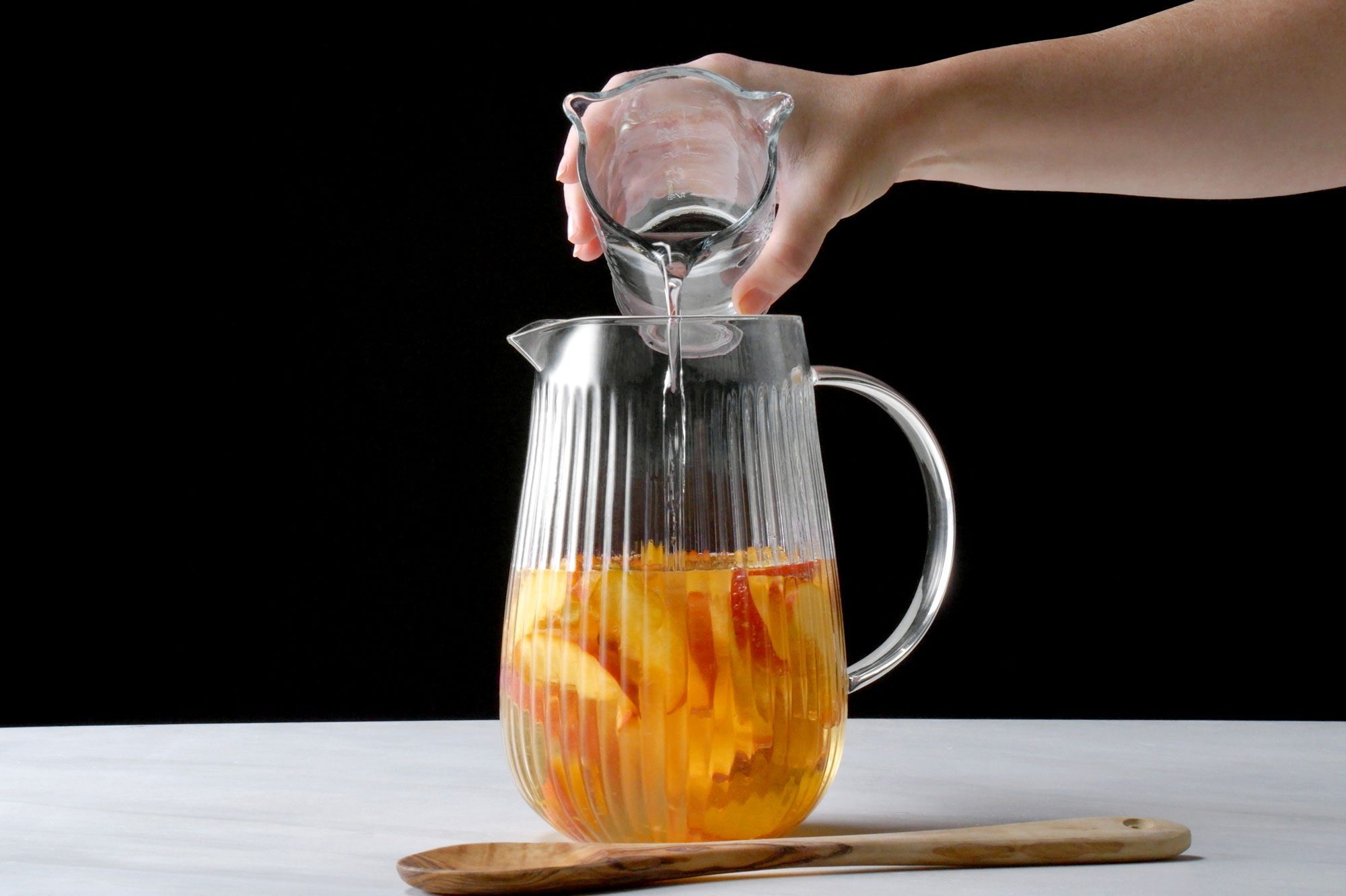 Sparkling water added in the sangria mix in a jar