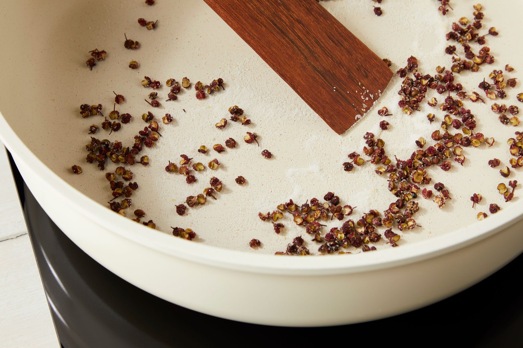 In a large deep skillet over medium heat, cook and stir peppercorns and 3 teaspoons salt until fragrant