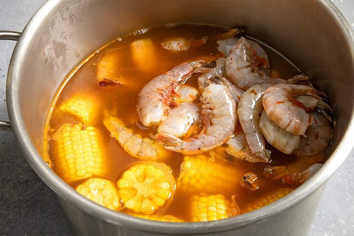 close shot of shrimps added in the mix in a stockpot