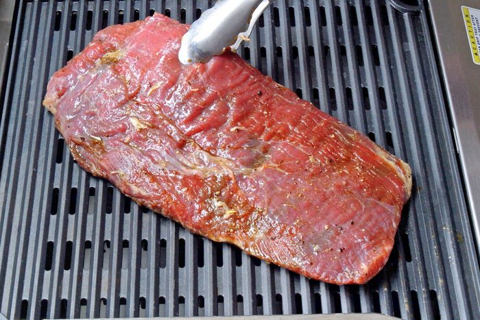 Grill the steak over medium-high heat for six to eight minutes on each side