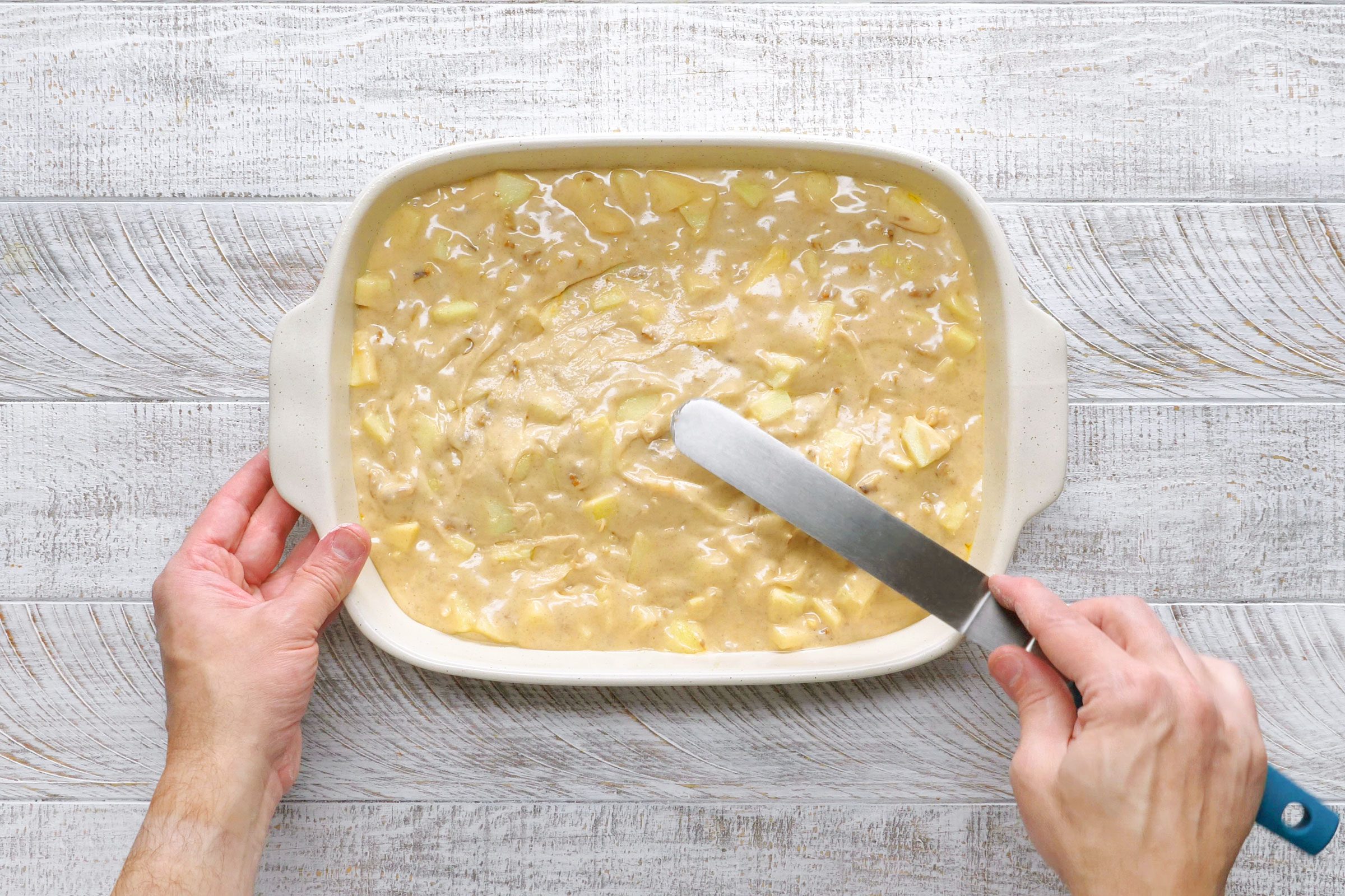 apple cake batter in a baking dish before baking
