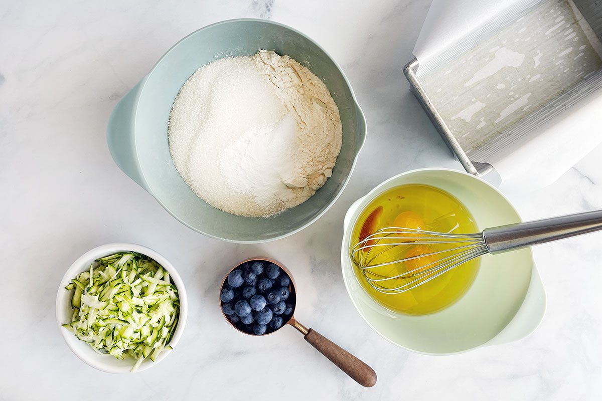Step one in making Taste of Home's Blueberry Zucchini Bread involves mixing wet and dry ingredients together
