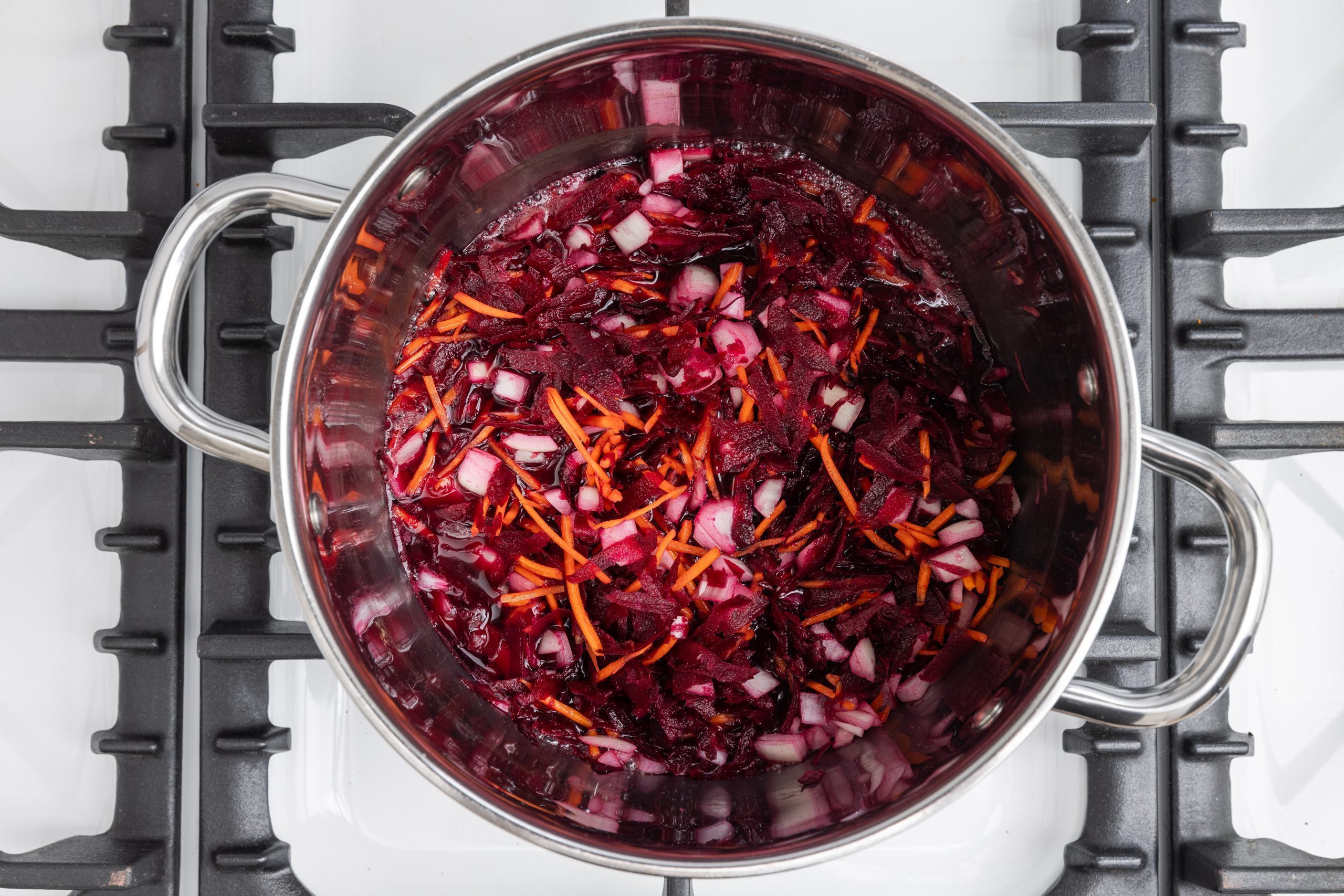 Carrots, beets and onions cooking in water.