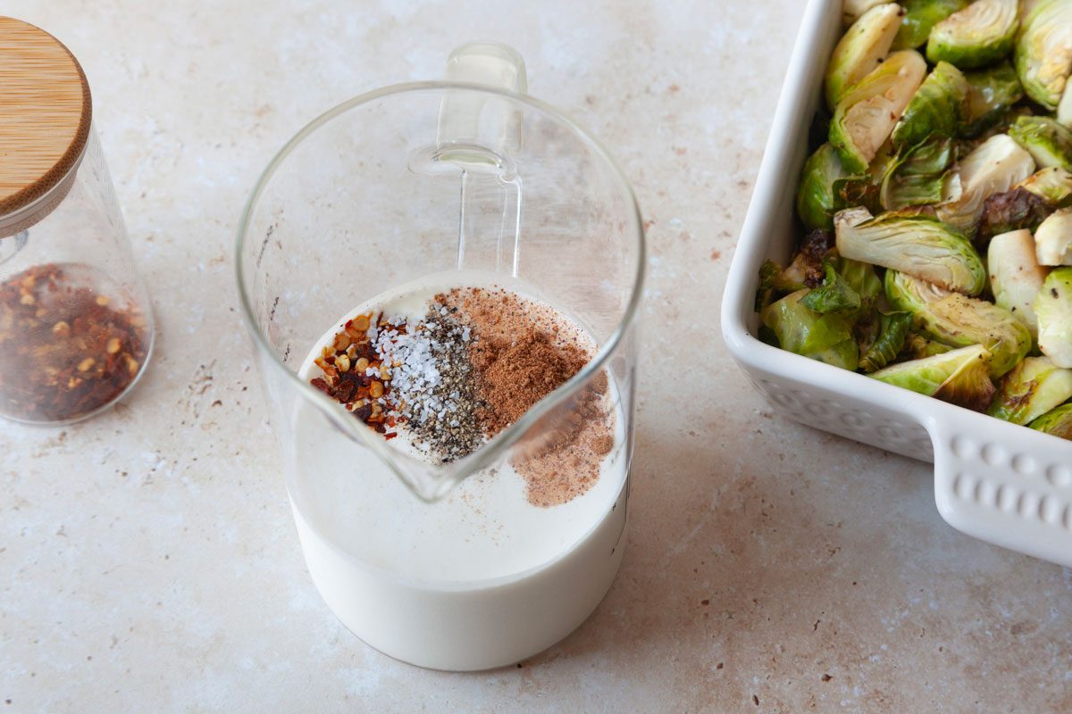 Step 3 of Taste of Home Brussels Sprouts au Gratin is to mix the cream and seasonings and pour over Brussels into pan