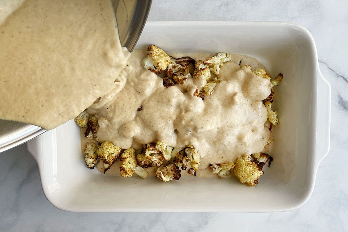 How to make Taste of Home's Cauliflower Gratin, step 4: pour cream sauce over roasted cauliflower in a baking dish