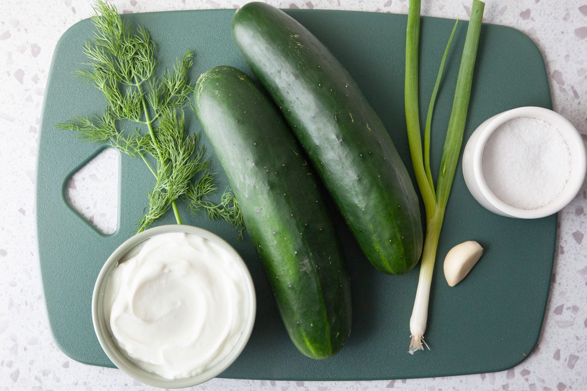 Ingredient shot of Taste of Home Cucumber Soup on a green cutting board from overhead