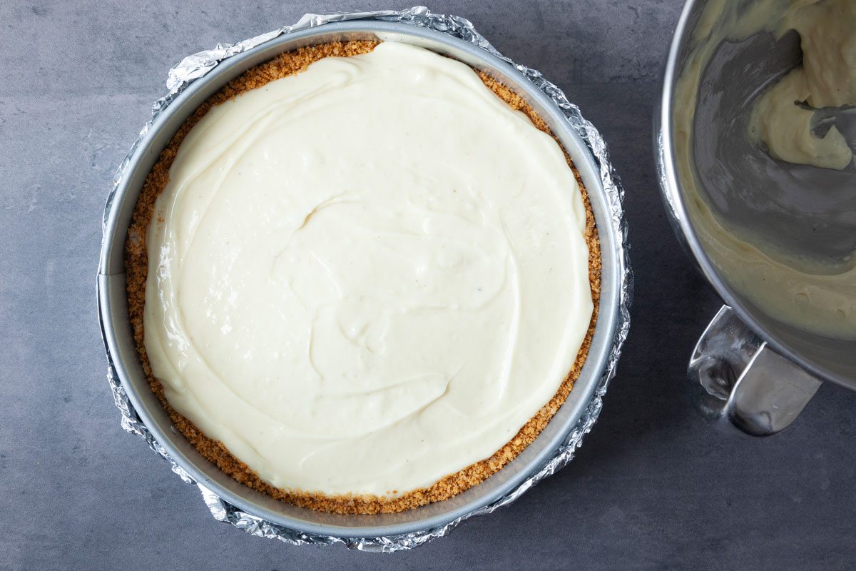 Step 3 one Taste of Home Eggnog Cheesecake is to make the cream cheese filling and spread it evenly into the baked crust