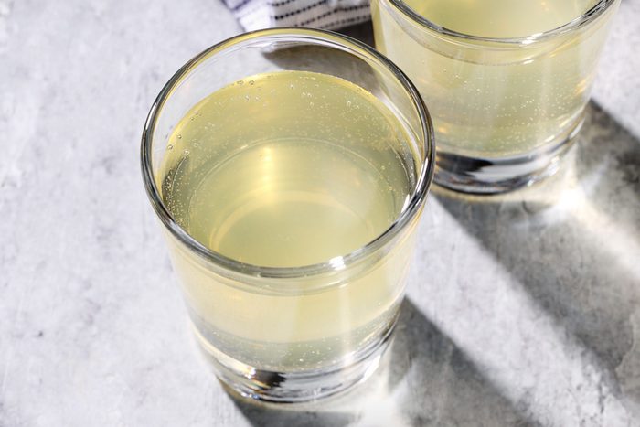 Top view shot of Green Tea Shots; served in glasses; napkin; marble background;