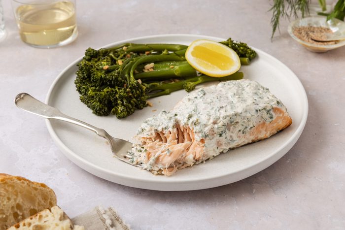 Herb grilled salmon served on plate with a piece of salmon on the fork.