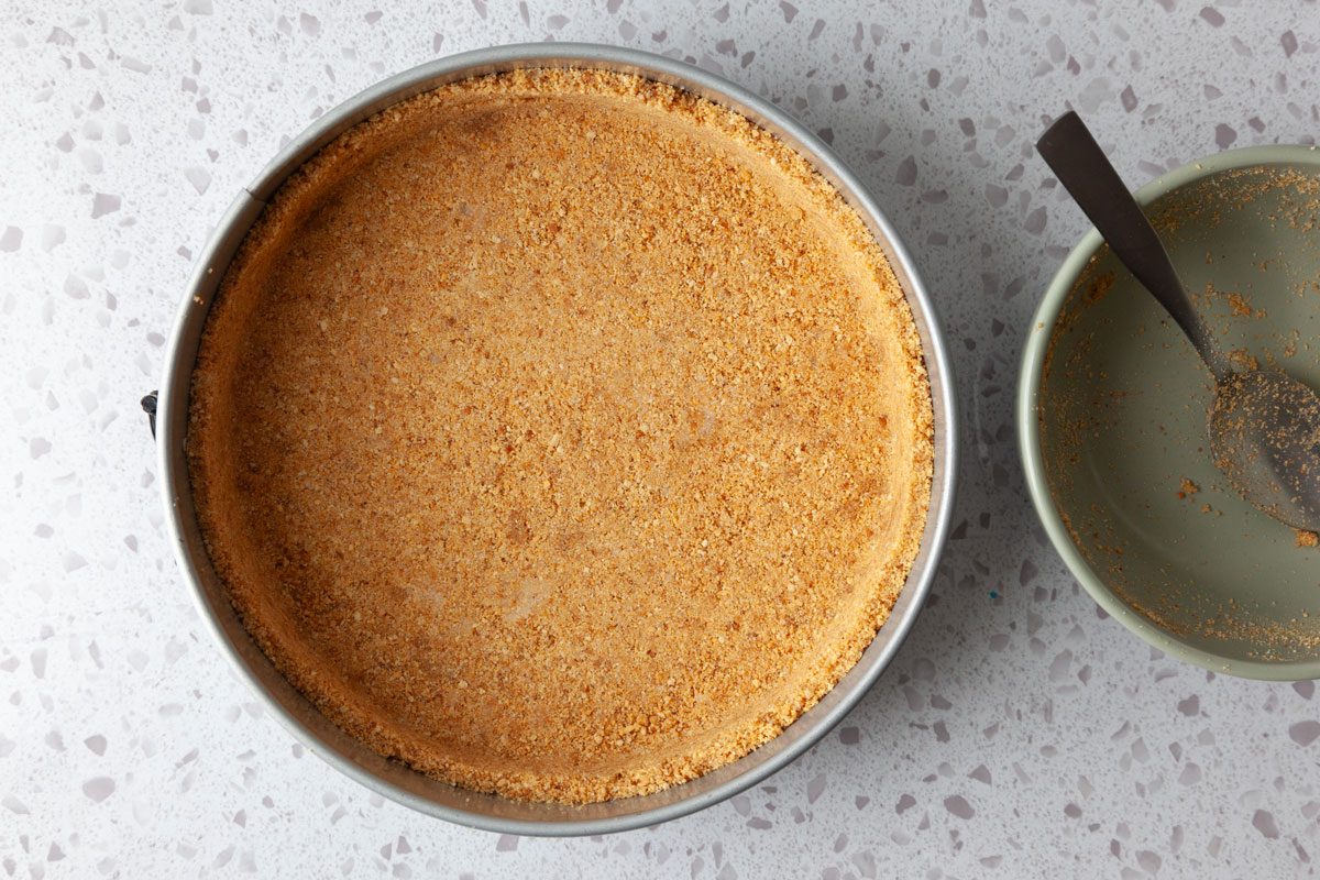 Step 1 of Taste of Home Mango Cheesecake is to make the crust and press it into the pan
