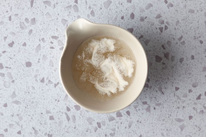 Step 2 of Taste of Home Mango Cheesecake is to dissolve the gelatin in water