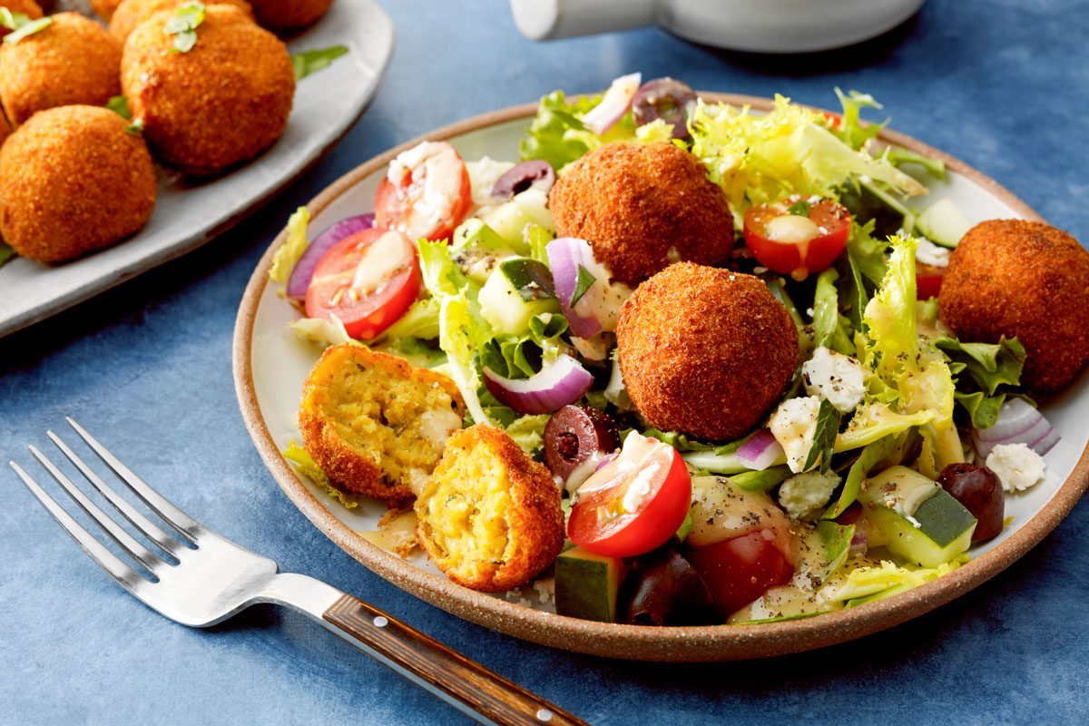Chickpea Meatballs served with a salad on a plate