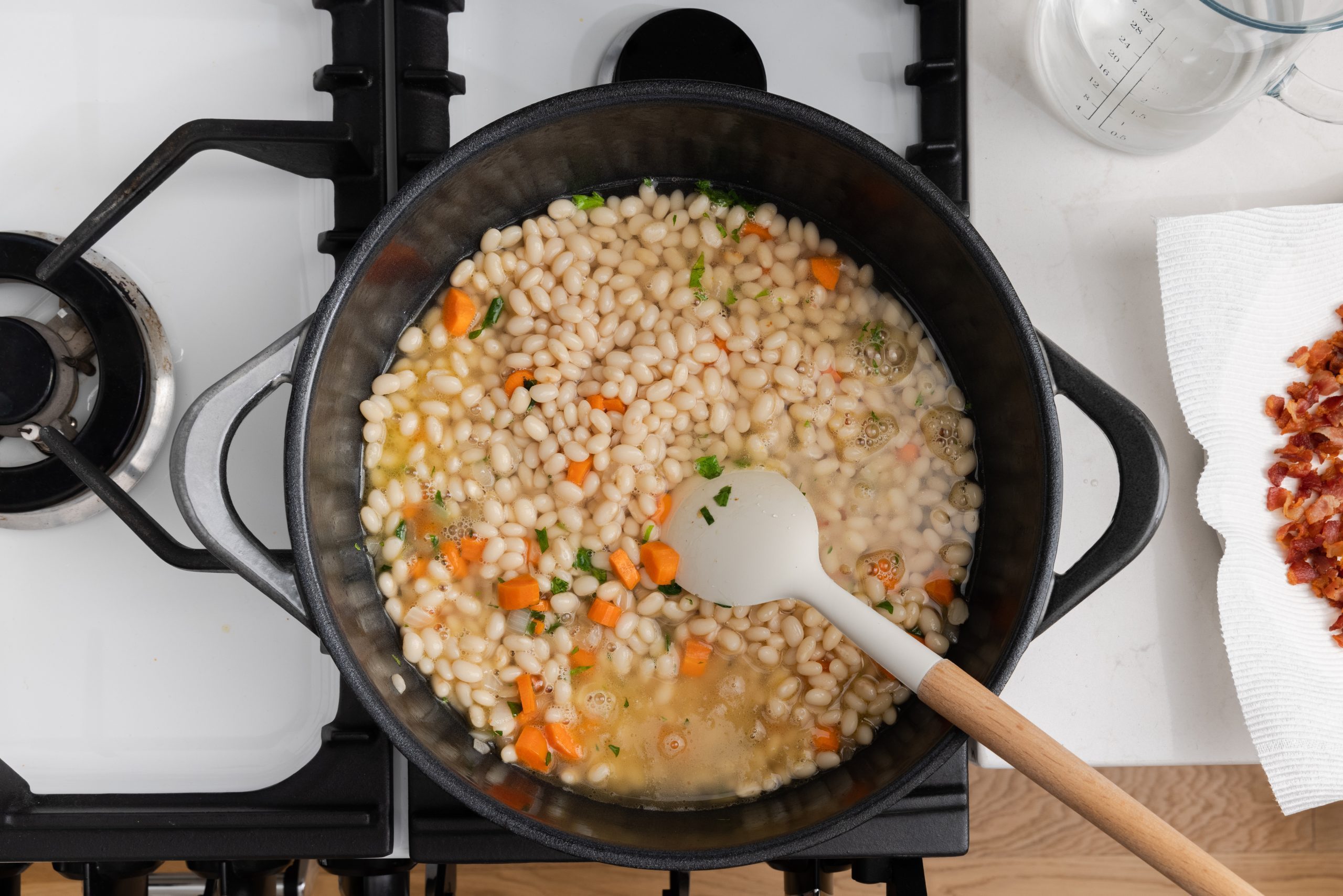 Beans and vegetables cooking in dutch oven. 