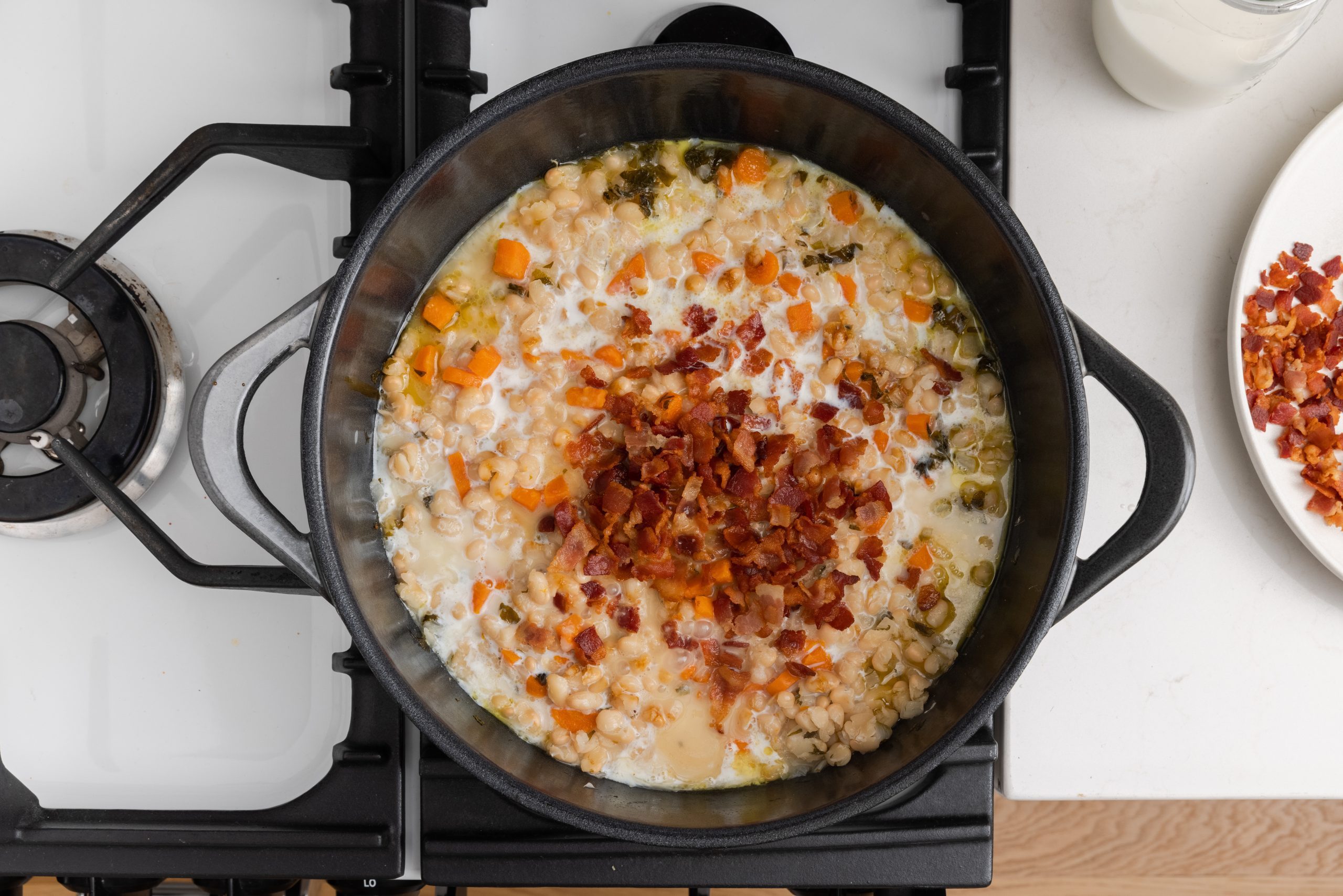 Yankee beans soup being finished in dutch oven. 