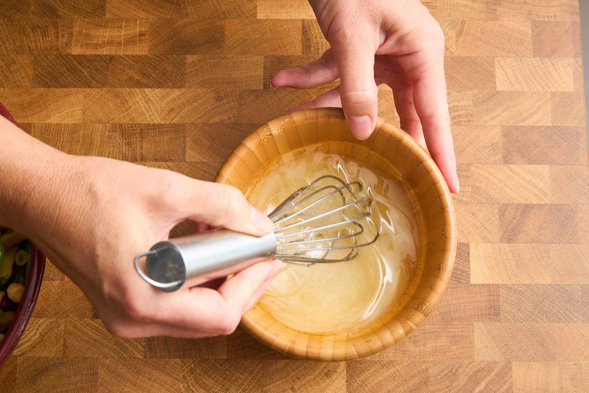 Close up of mixing salad dressing in small mixing bowl