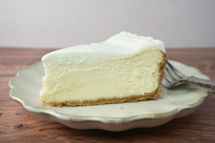 A slice of amaretto cheesecake on a plate with a fork RMS 91184 for Taste of Home