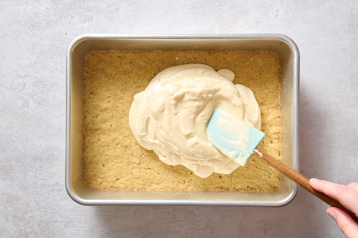 Spreading cheesecake filling over the crust