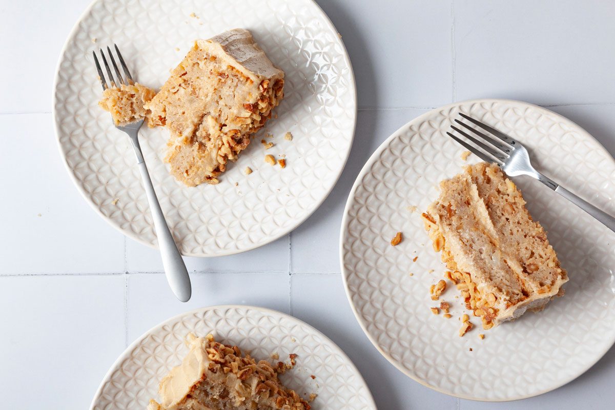 Single servings of Taste of Home Apple Spice Cake on a white tile surface on white plates.