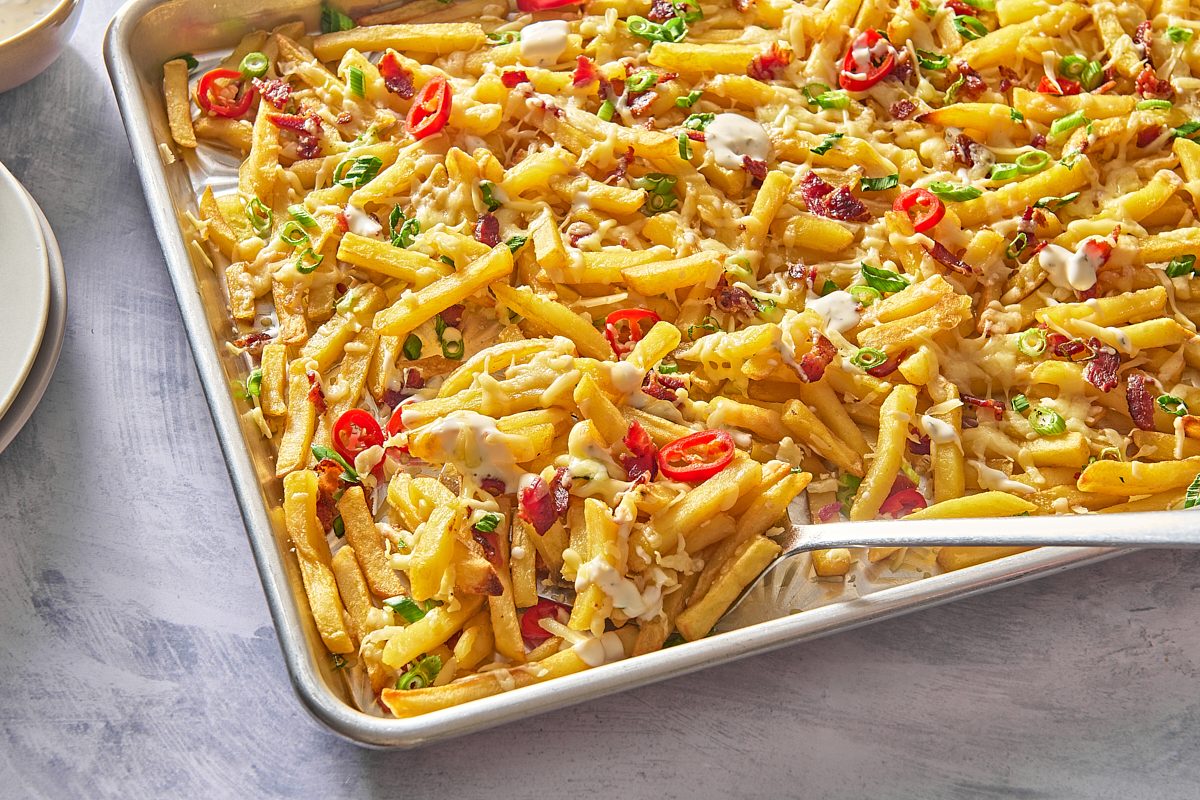 Closeup shot of bacon cheese fries being served