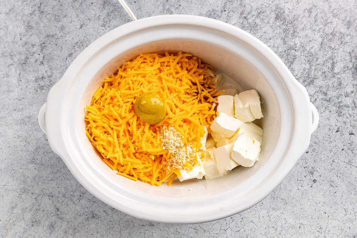Taste of Home Bacon Dip recipe photo of the cheese ingredients in a slow cooker. 