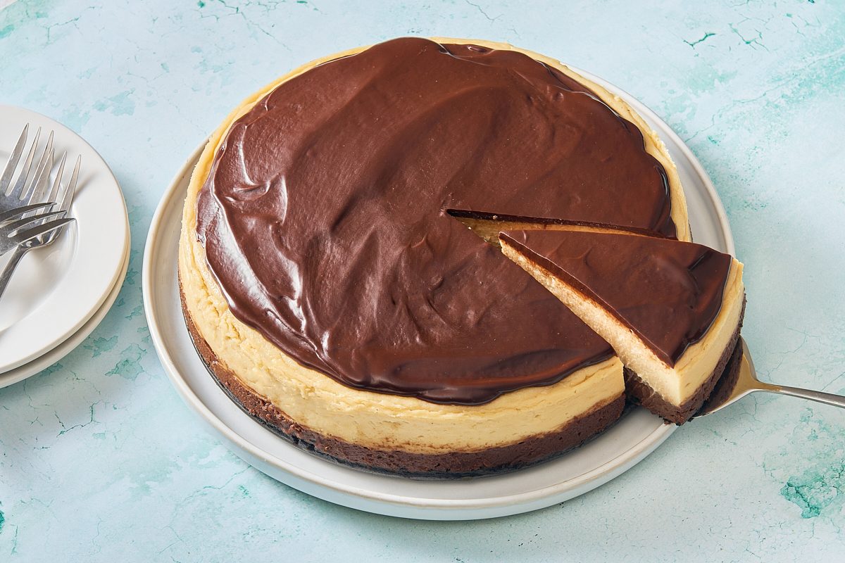 Shot of Baileys cheesecake with one slice being removed