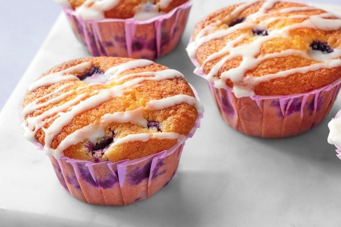 Close up shot of blue berry lemon muffins with glaze on top